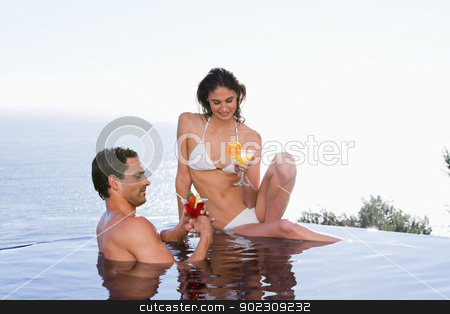 To use this stock image in your creative project, please select the size you need over to the right and click the "Add to Cart" button.
Your downloaded image will come with the Cutcaster watermark removed so don’t worry about the watermark you see on this page. Young couple having a cocktail stock photo, Young couple having a cocktail in a swimming pool by Wavebreak Media