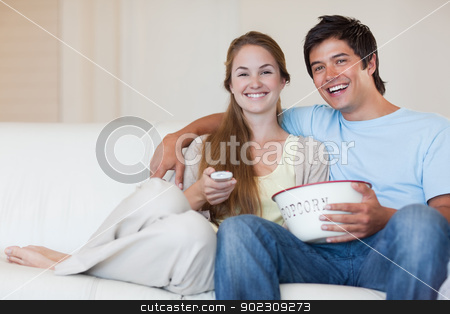 To use this stock image in your creative project, please select the size you need over to the right and click the "Add to Cart" button.
Your downloaded image will come with the Cutcaster watermark removed so don’t worry about the watermark you see on this page. Couple watching television while eating popcorn stock photo, Couple watching television while eating popcorn in their living room by Wavebreak Media