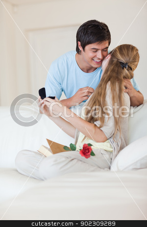 To use this stock image in your creative project, please select the size you need over to the right and click the "Add to Cart" button.
Your downloaded image will come with the Cutcaster watermark removed so don’t worry about the watermark you see on this page. Portrait of a man offering a jewel to his girlfriend stock photo, Portrait of a man offering a jewel to his girlfriend in their living room by Wavebreak Media