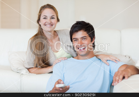 To use this stock image in your creative project, please select the size you need over to the right and click the "Add to Cart" button.
Your downloaded image will come with the Cutcaster watermark removed so don’t worry about the watermark you see on this page. Young couple watching television stock photo, Young couple watching television in their living room by Wavebreak Media