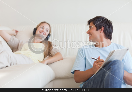To use this stock image in your creative project, please select the size you need over to the right and click the "Add to Cart" button.
Your downloaded image will come with the Cutcaster watermark removed so don’t worry about the watermark you see on this page. Man doing crosswords while his girlfriend is listening to music stock photo, Man doing crosswords while his girlfriend is listening to music in their living room by Wavebreak Media