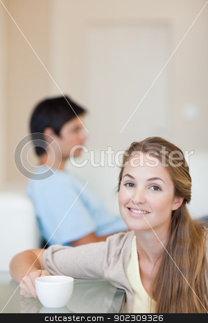 To use this stock image in your creative project, please select the size you need over to the right and click the "Add to Cart" button.
Your downloaded image will come with the Cutcaster watermark removed so don’t worry about the watermark you see on this page. Portrait of a woman having a cup of tea while her husband is sit stock photo, Portrait of a woman having a cup of tea while her husband is sitting on a sofa in their living room by Wavebreak Media