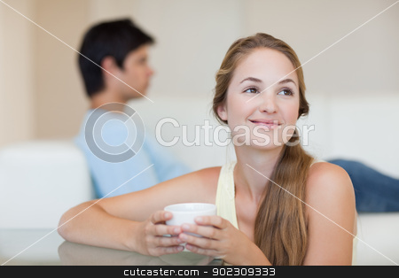 To use this stock image in your creative project, please select the size you need over to the right and click the "Add to Cart" button.
Your downloaded image will come with the Cutcaster watermark removed so don’t worry about the watermark you see on this page. Woman drinking coffee while her fiance is sitting on a couch stock photo, Woman drinking coffee while her fiance is sitting on a couch in their living room by Wavebreak Media