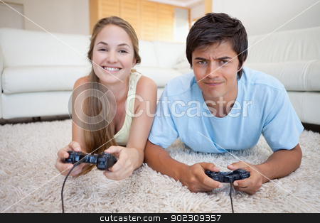 To use this stock image in your creative project, please select the size you need over to the right and click the "Add to Cart" button.
Your downloaded image will come with the Cutcaster watermark removed so don’t worry about the watermark you see on this page. Cheerful couple playing video games stock photo, Cheerful couple playing video games in their living room by Wavebreak Media