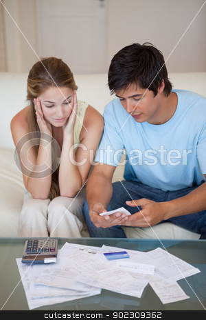 To use this stock image in your creative project, please select the size you need over to the right and click the "Add to Cart" button.
Your downloaded image will come with the Cutcaster watermark removed so don’t worry about the watermark you see on this page. Portrait of a couple looking at their bills stock photo, Portrait of a couple looking at their bills in their living room by Wavebreak Media