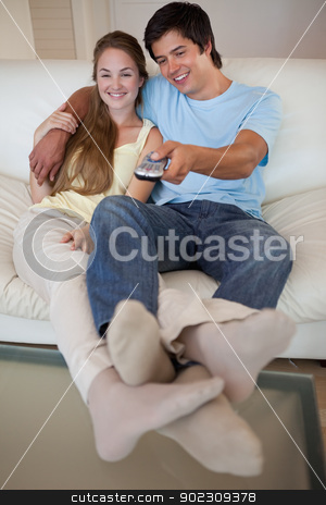 To use this stock image in your creative project, please select the size you need over to the right and click the "Add to Cart" button.
Your downloaded image will come with the Cutcaster watermark removed so don’t worry about the watermark you see on this page. Portrait of a relaxed couple watching television stock photo, Portrait of a relaxed couple watching television in their living room by Wavebreak Media