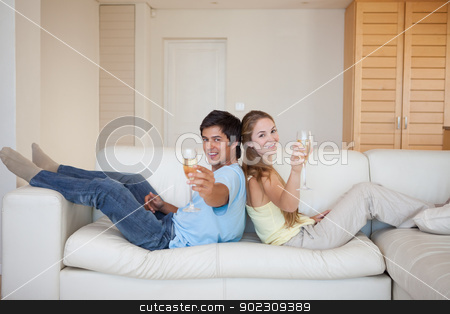 To use this stock image in your creative project, please select the size you need over to the right and click the "Add to Cart" button.
Your downloaded image will come with the Cutcaster watermark removed so don’t worry about the watermark you see on this page. Couple sitting back to back with a glass of sparkling wine stock photo, Couple sitting back to back with a glass of sparkling wine in their living room by Wavebreak Media