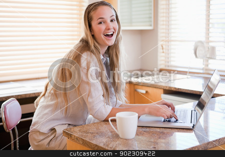 To use this stock image in your creative project, please select the size you need over to the right and click the "Add to Cart" button.
Your downloaded image will come with the Cutcaster watermark removed so don’t worry about the watermark you see on this page. Woman having tea while using a laptop stock photo, Woman having tea while using a laptop in her kitchen by Wavebreak Media