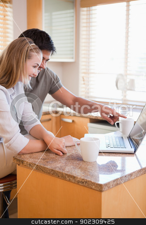 To use this stock image in your creative project, please select the size you need over to the right and click the "Add to Cart" button.
Your downloaded image will come with the Cutcaster watermark removed so don’t worry about the watermark you see on this page. Portrait of a couple having tea while using a laptop stock photo, Portrait of a couple having tea while using a laptop in their kitchen by Wavebreak Media