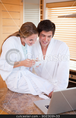 To use this stock image in your creative project, please select the size you need over to the right and click the "Add to Cart" button.
Your downloaded image will come with the Cutcaster watermark removed so don’t worry about the watermark you see on this page. Portrait of a couple having breakfast during a video conference stock photo, Portrait of a couple having breakfast during a video conference in their kitchen by Wavebreak Media