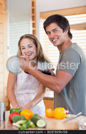 To use this stock image in your creative project, please select the size you need over to the right and click the "Add to Cart" button.
Your downloaded image will come with the Cutcaster watermark removed so don’t worry about the watermark you see on this page. Portrait of a smiling couple preparing dinner stock photo, Portrait of a smiling couple preparing dinner in their kitchen by Wavebreak Media