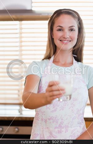 To use this stock image in your creative project, please select the size you need over to the right and click the "Add to Cart" button.
Your downloaded image will come with the Cutcaster watermark removed so don’t worry about the watermark you see on this page. Portrait of a young woman giving a glass of milk stock photo, Portrait of a young woman giving a glass of milk in her kitchen by Wavebreak Media