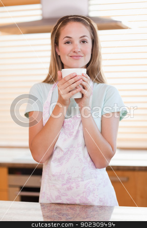 To use this stock image in your creative project, please select the size you need over to the right and click the "Add to Cart" button.
Your downloaded image will come with the Cutcaster watermark removed so don’t worry about the watermark you see on this page. Portrait of a woman drinking a cup of tea stock photo, Portrait of a woman drinking a cup of tea in her kitchen by Wavebreak Media