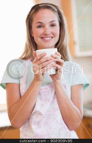 To use this stock image in your creative project, please select the size you need over to the right and click the "Add to Cart" button.
Your downloaded image will come with the Cutcaster watermark removed so don’t worry about the watermark you see on this page. Portrait of a woman drinking a cup of coffee stock photo, Portrait of a woman drinking a cup of coffee in her kitchen by Wavebreak Media