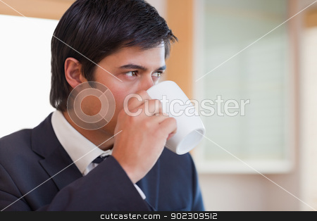 To use this stock image in your creative project, please select the size you need over to the right and click the "Add to Cart" button.
Your downloaded image will come with the Cutcaster watermark removed so don’t worry about the watermark you see on this page. Close up of a businessman drinking tea stock photo, Close up of a businessman drinking tea in his kitchen by Wavebreak Media