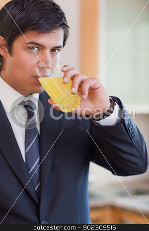 To use this stock image in your creative project, please select the size you need over to the right and click the "Add to Cart" button.
Your downloaded image will come with the Cutcaster watermark removed so don’t worry about the watermark you see on this page. Portrait of a businessman drinking orange juice stock photo, Portrait of a businessman drinking orange juice in his kitchen by Wavebreak Media