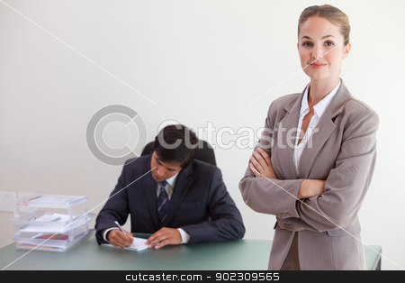 To use this stock image in your creative project, please select the size you need over to the right and click the "Add to Cart" button.
Your downloaded image will come with the Cutcaster watermark removed so don’t worry about the watermark you see on this page. Young busineswosman posing while her colleague is working stock photo, Young busineswosman posing while her colleague is working in an office by Wavebreak Media