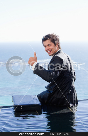 To use this stock image in your creative project, please select the size you need over to the right and click the "Add to Cart" button.
Your downloaded image will come with the Cutcaster watermark removed so don’t worry about the watermark you see on this page. Portrait of a businessman with the thumb up stock photo, Portrait of a businessman with the thumb up in a swimming pool by Wavebreak Media