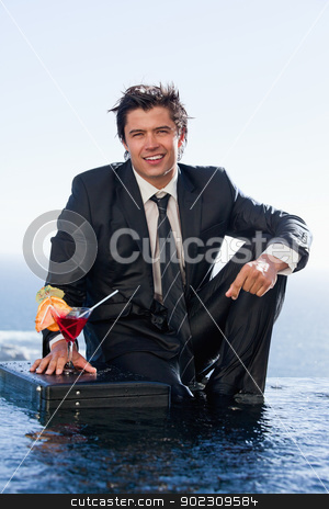 To use this stock image in your creative project, please select the size you need over to the right and click the "Add to Cart" button.
Your downloaded image will come with the Cutcaster watermark removed so don’t worry about the watermark you see on this page. Portrait of a businessman posing with a cocktail in a briefcase stock photo, Portrait of a businessman posing with a cocktail in a briefcase in a swimming pool by Wavebreak Media