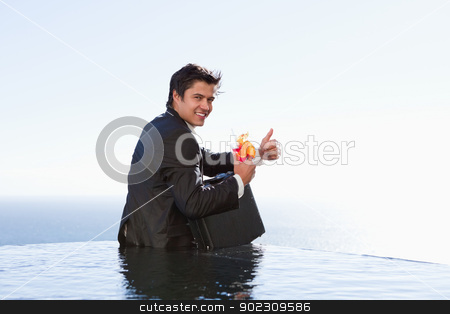 To use this stock image in your creative project, please select the size you need over to the right and click the "Add to Cart" button.
Your downloaded image will come with the Cutcaster watermark removed so don’t worry about the watermark you see on this page. Portrait of a businessman posing with a cocktail and a briefcase stock photo, Portrait of a businessman posing with a cocktail and a briefcase in a swimming pool by Wavebreak Media