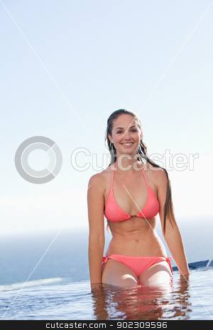 To use this stock image in your creative project, please select the size you need over to the right and click the "Add to Cart" button.
Your downloaded image will come with the Cutcaster watermark removed so don’t worry about the watermark you see on this page. Portrait of a woman in a bikini stock photo, Portrait of a woman in a bikini sitting by a swimming pool by Wavebreak Media
