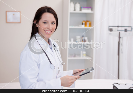 To use this stock image in your creative project, please select the size you need over to the right and click the "Add to Cart" button.
Your downloaded image will come with the Cutcaster watermark removed so don’t worry about the watermark you see on this page. Smiling doctor using a tablet computer stock photo, Smiling doctor using a tablet computer in a hospital by Wavebreak Media