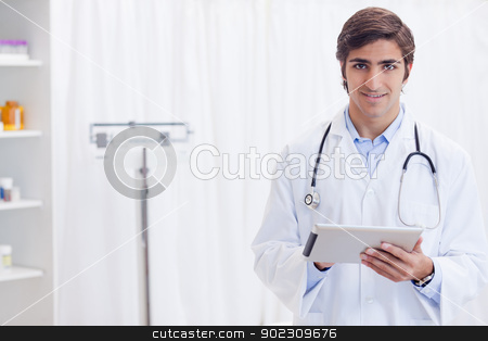 To use this stock image in your creative project, please select the size you need over to the right and click the "Add to Cart" button.
Your downloaded image will come with the Cutcaster watermark removed so don’t worry about the watermark you see on this page. Smiling doctor with tablet stock photo, Smiling young doctor with tablet by Wavebreak Media