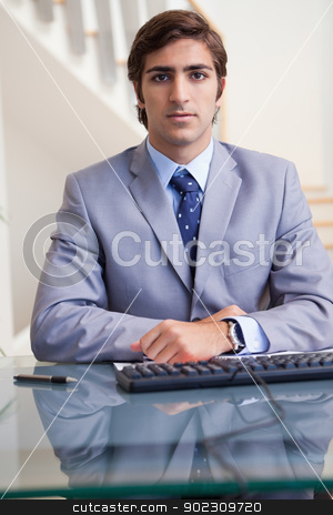 To use this stock image in your creative project, please select the size you need over to the right and click the "Add to Cart" button.
Your downloaded image will come with the Cutcaster watermark removed so don’t worry about the watermark you see on this page. Businessman sitting behind his desk stock photo, Young businessman sitting behind his desk by Wavebreak Media