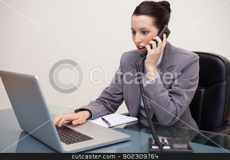 To use this stock image in your creative project, please select the size you need over to the right and click the "Add to Cart" button.
Your downloaded image will come with the Cutcaster watermark removed so don’t worry about the watermark you see on this page. Businesswoman typing on laptop while talking on the phone stock photo, Young businesswoman typing on laptop while talking on the phone by Wavebreak Media