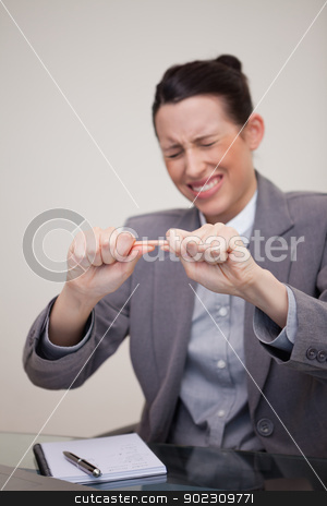To use this stock image in your creative project, please select the size you need over to the right and click the "Add to Cart" button.
Your downloaded image will come with the Cutcaster watermark removed so don’t worry about the watermark you see on this page. Angry businesswoman trying to break pencil stock photo, Angry young businesswoman trying to break pencil by Wavebreak Media