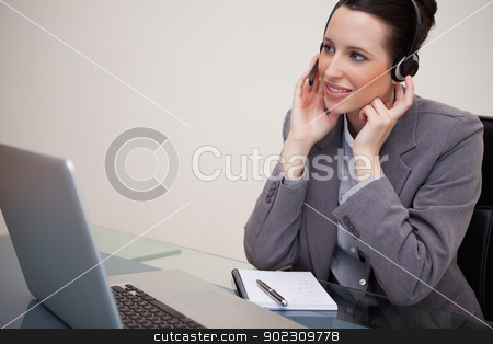 To use this stock image in your creative project, please select the size you need over to the right and click the "Add to Cart" button.
Your downloaded image will come with the Cutcaster watermark removed so don’t worry about the watermark you see on this page. Businesswoman with headset sitting at her desk stock photo, Young businesswoman with headset sitting at her desk by Wavebreak Media