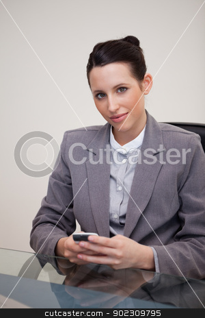 To use this stock image in your creative project, please select the size you need over to the right and click the "Add to Cart" button.
Your downloaded image will come with the Cutcaster watermark removed so don’t worry about the watermark you see on this page. Businesswoman behind desk with cellphone stock photo, Young businesswoman behind desk with cellphone by Wavebreak Media
