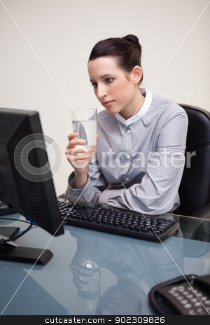 To use this stock image in your creative project, please select the size you need over to the right and click the "Add to Cart" button.
Your downloaded image will come with the Cutcaster watermark removed so don’t worry about the watermark you see on this page. Businesswoman at her desk with a glass of water stock photo, Young businesswoman at her desk with a glass of water by Wavebreak Media