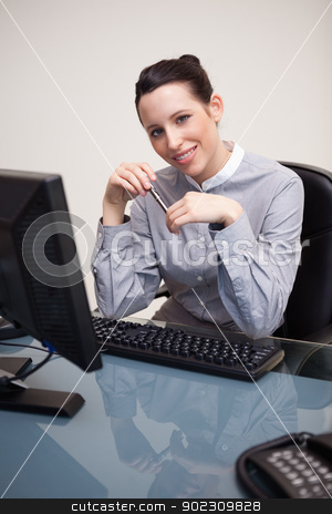 To use this stock image in your creative project, please select the size you need over to the right and click the "Add to Cart" button.
Your downloaded image will come with the Cutcaster watermark removed so don’t worry about the watermark you see on this page. Smiling businesswoman with pen sitting at her desk stock photo, Smiling young businesswoman with pen sitting at her desk by Wavebreak Media