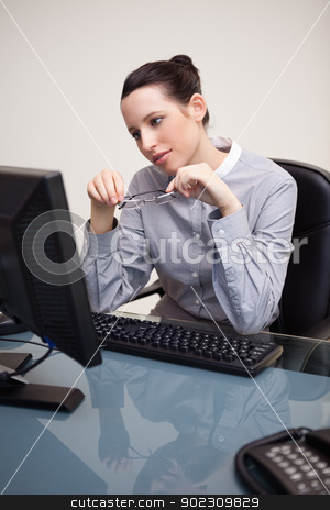 To use this stock image in your creative project, please select the size you need over to the right and click the "Add to Cart" button.
Your downloaded image will come with the Cutcaster watermark removed so don’t worry about the watermark you see on this page. Businesswoman looking at screen holding her glasses stock photo, Young businesswoman looking at screen holding her glasses by Wavebreak Media