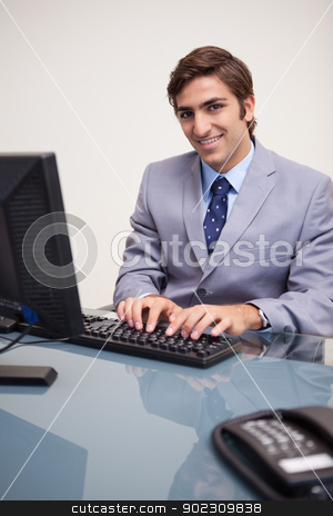 To use this stock image in your creative project, please select the size you need over to the right and click the "Add to Cart" button.
Your downloaded image will come with the Cutcaster watermark removed so don’t worry about the watermark you see on this page. Smiling businessman typing on his keyboard stock photo, Smiling young businessman typing on his keyboard by Wavebreak Media