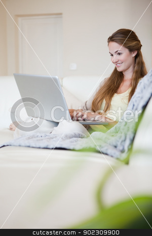 To use this stock image in your creative project, please select the size you need over to the right and click the "Add to Cart" button.
Your downloaded image will come with the Cutcaster watermark removed so don’t worry about the watermark you see on this page. Side view of smiling woman working on her laptop on the sofa stock photo, Side view of smiling young woman working on her laptop on the sofa by Wavebreak Media
