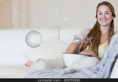To use this stock image in your creative project, please select the size you need over to the right and click the "Add to Cart" button.
Your downloaded image will come with the Cutcaster watermark removed so don’t worry about the watermark you see on this page. Woman having some popcorn while enjoying a movie stock photo, Young woman having some popcorn while enjoying a movie by Wavebreak Media