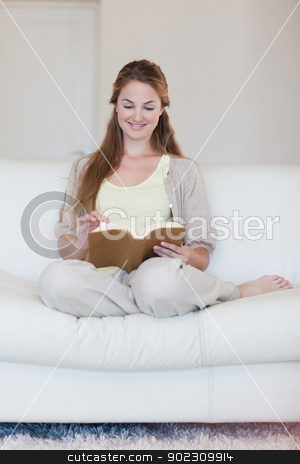 To use this stock image in your creative project, please select the size you need over to the right and click the "Add to Cart" button.
Your downloaded image will come with the Cutcaster watermark removed so don’t worry about the watermark you see on this page. Woman enjoys reading a book on her sofa stock photo, Young woman enjoys reading a book on her sofa by Wavebreak Media