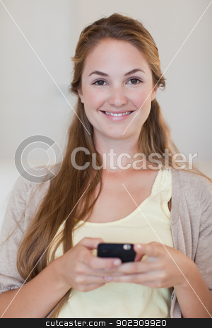 To use this stock image in your creative project, please select the size you need over to the right and click the "Add to Cart" button.
Your downloaded image will come with the Cutcaster watermark removed so don’t worry about the watermark you see on this page. Smiling woman holding her cellphone stock photo, Smiling young woman holding her cellphone by Wavebreak Media