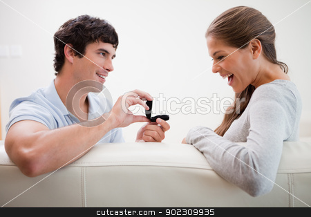 To use this stock image in your creative project, please select the size you need over to the right and click the "Add to Cart" button.
Your downloaded image will come with the Cutcaster watermark removed so don’t worry about the watermark you see on this page. Man making a proposal to his girlfriend stock photo, Young man making a proposal to his girlfriend by Wavebreak Media