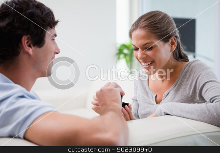 To use this stock image in your creative project, please select the size you need over to the right and click the "Add to Cart" button.
Your downloaded image will come with the Cutcaster watermark removed so don’t worry about the watermark you see on this page. Man making a proposal to his girlfriend on the sofa stock photo, Young man making a proposal to his girlfriend on the sofa by Wavebreak Media