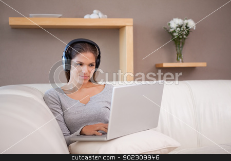 To use this stock image in your creative project, please select the size you need over to the right and click the "Add to Cart" button.
Your downloaded image will come with the Cutcaster watermark removed so don’t worry about the watermark you see on this page. Woman with headphones on her laptop stock photo, Young woman with headphones on her laptop by Wavebreak Media