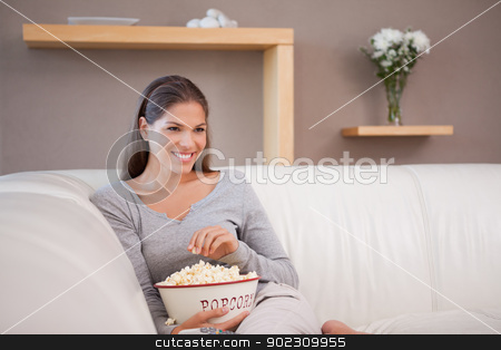 To use this stock image in your creative project, please select the size you need over to the right and click the "Add to Cart" button.
Your downloaded image will come with the Cutcaster watermark removed so don’t worry about the watermark you see on this page. Smiling woman having popcorn while watching a movie stock photo, Smiling young woman having popcorn while watching a movie by Wavebreak Media
