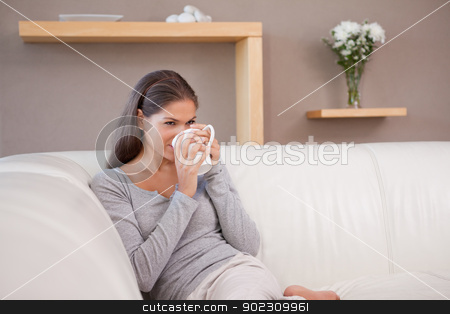 To use this stock image in your creative project, please select the size you need over to the right and click the "Add to Cart" button.
Your downloaded image will come with the Cutcaster watermark removed so don’t worry about the watermark you see on this page. Woman drinking some coffee on the sofa stock photo, Young woman drinking some coffee on the sofa by Wavebreak Media