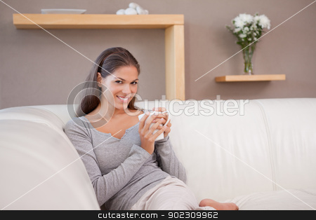 To use this stock image in your creative project, please select the size you need over to the right and click the "Add to Cart" button.
Your downloaded image will come with the Cutcaster watermark removed so don’t worry about the watermark you see on this page. Woman with a cup of coffee on the sofa stock photo, Young woman with a cup of coffee on the sofa by Wavebreak Media