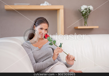 To use this stock image in your creative project, please select the size you need over to the right and click the "Add to Cart" button.
Your downloaded image will come with the Cutcaster watermark removed so don’t worry about the watermark you see on this page. Woman with a red rose sitting on the couch stock photo, Young woman with a red rose sitting on the couch by Wavebreak Media