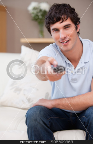 To use this stock image in your creative project, please select the size you need over to the right and click the "Add to Cart" button.
Your downloaded image will come with the Cutcaster watermark removed so don’t worry about the watermark you see on this page. Man on the sofa switching on television stock photo, Young man on the sofa switching on television by Wavebreak Media
