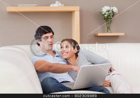 To use this stock image in your creative project, please select the size you need over to the right and click the "Add to Cart" button.
Your downloaded image will come with the Cutcaster watermark removed so don’t worry about the watermark you see on this page. Couple with their laptop on the sofa stock photo, Young couple with their laptop on the sofa by Wavebreak Media