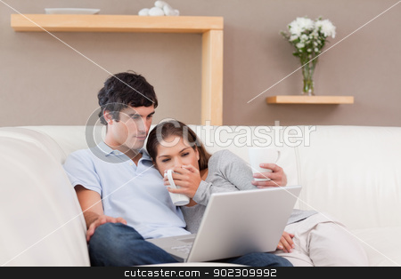 To use this stock image in your creative project, please select the size you need over to the right and click the "Add to Cart" button.
Your downloaded image will come with the Cutcaster watermark removed so don’t worry about the watermark you see on this page. Happy couple with their laptop on the sofa stock photo, Happy young couple with their laptop on the sofa by Wavebreak Media